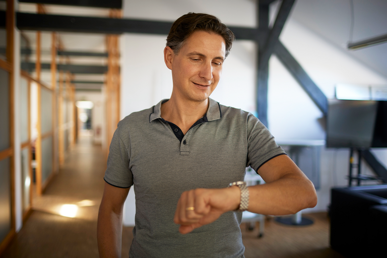 A colleague looks at his wristwatch