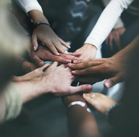 Hands interlock as a team